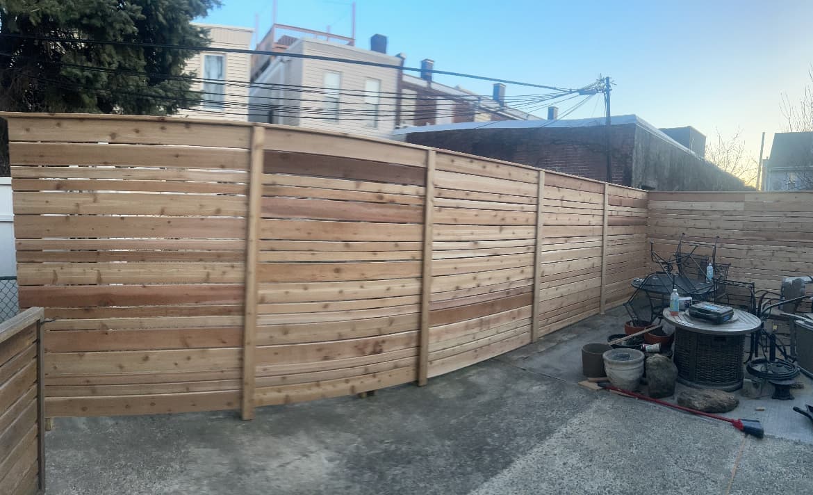 New cedar horizontal-slat privacy fence and cleaned-up patio